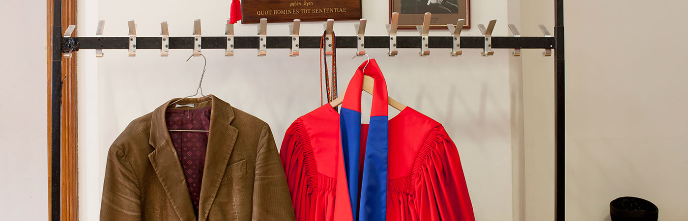 University gown hanging beside jacket