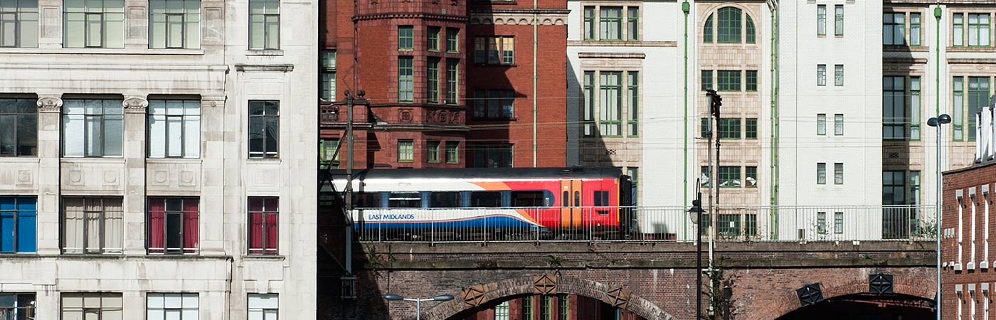 Train travelling through Manchester city centre