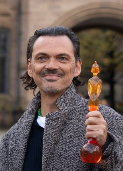 Manchester-born designer, Matthew Williamson, holding the 2026 BRIT Award trophy he designed. 