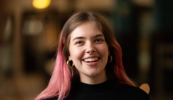 PhD student smiling at the camera