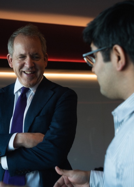 Professor Duncan Ivison in conversation with a man during a trip to India.