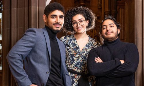 Three international students smiling. 