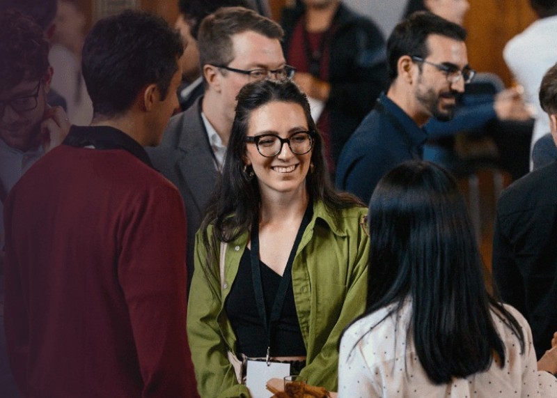 People smiling at a University event.