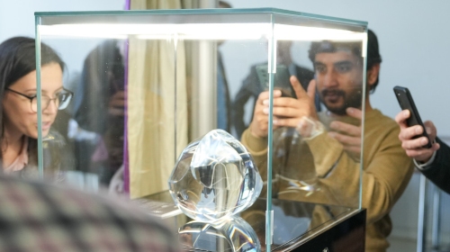 Onlookers take pictures of the Gömböc 1824 object.
