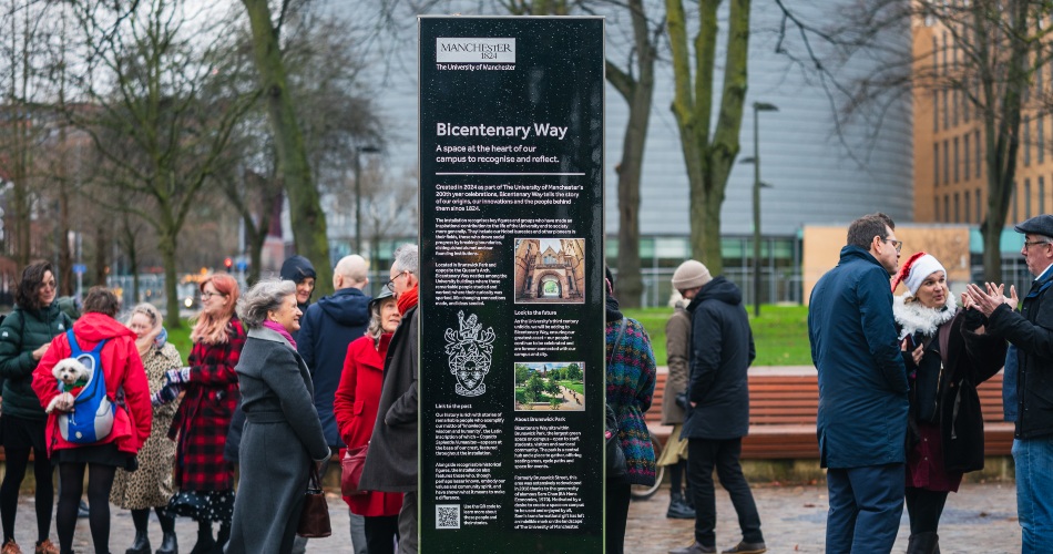 Event attendees walk close to the Bicentenary Way plinth.