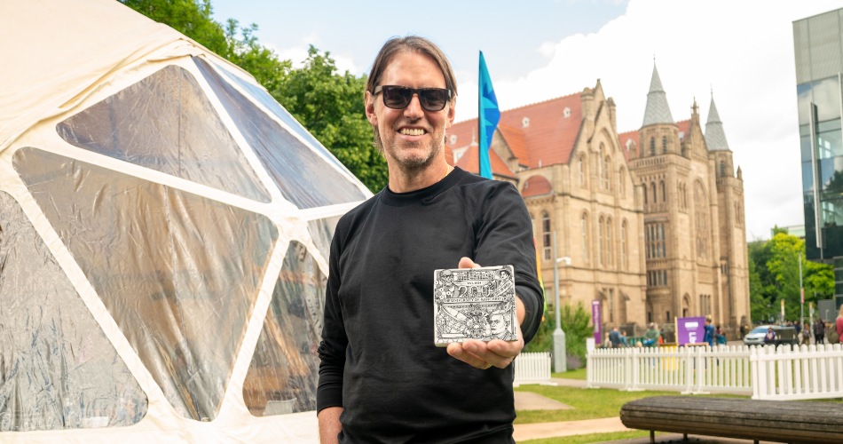 Ed O'Brien holds the commemorative tile at Universally Manchester Festival.