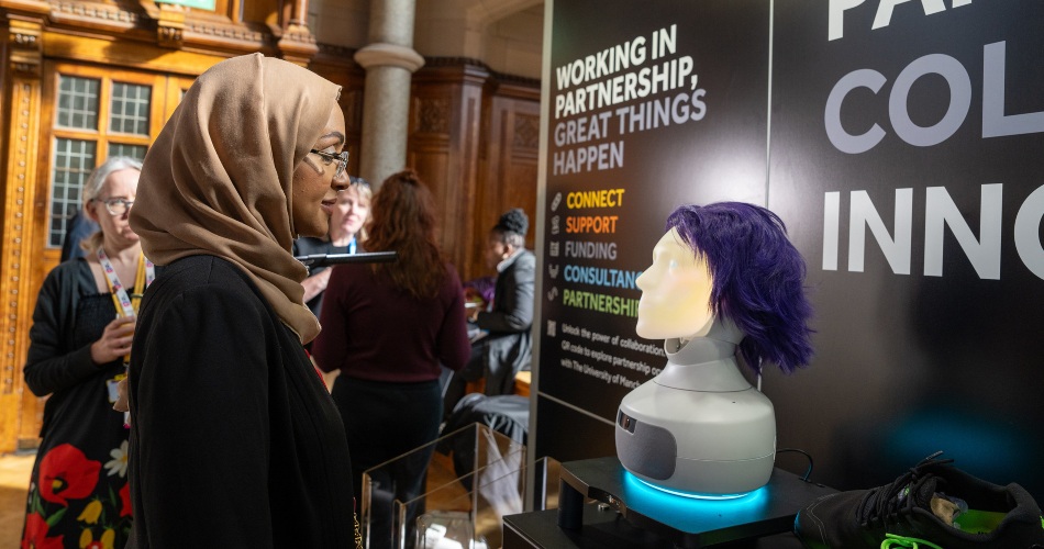A delegate peruses a stand in Whitworth Hall.