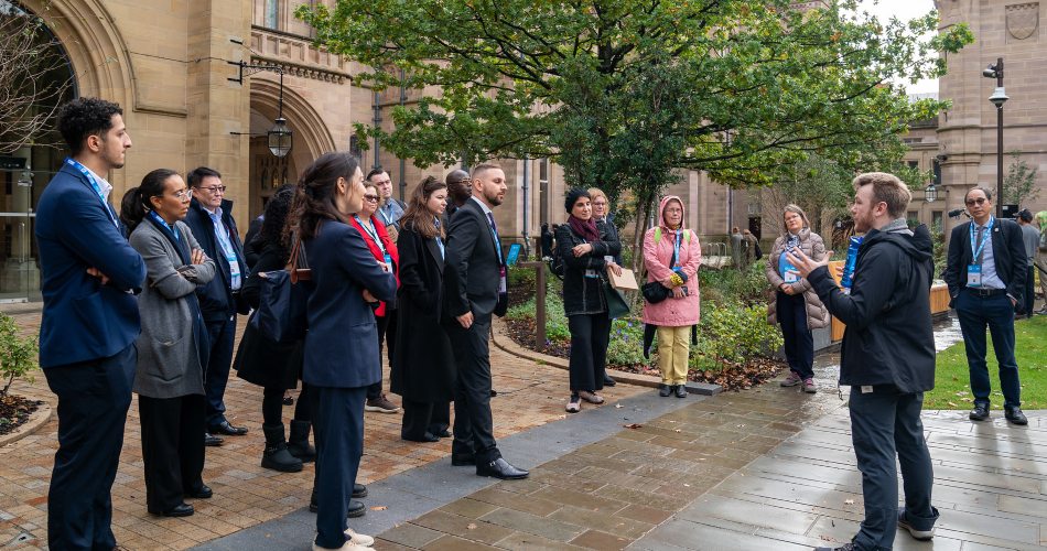 Dr Grant Collier leads delegates on a university tour.