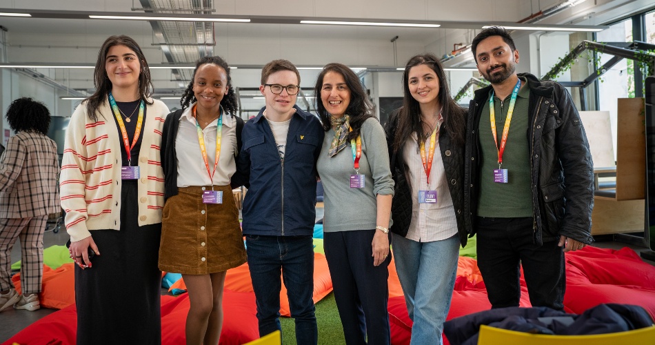 George Webster and event participants stand for a photograph.