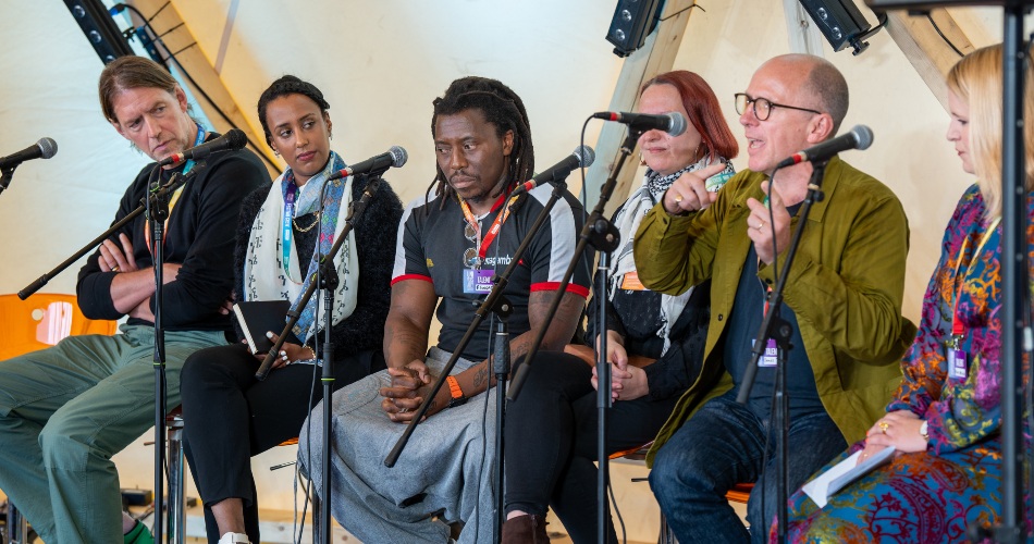 A panel discusses 20 years of In Place of War.