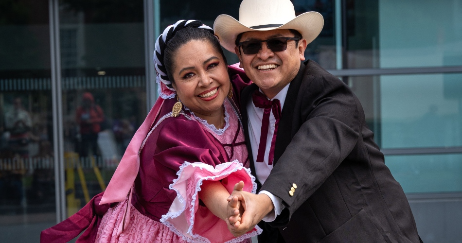 Mexican dancers smile for the camera.