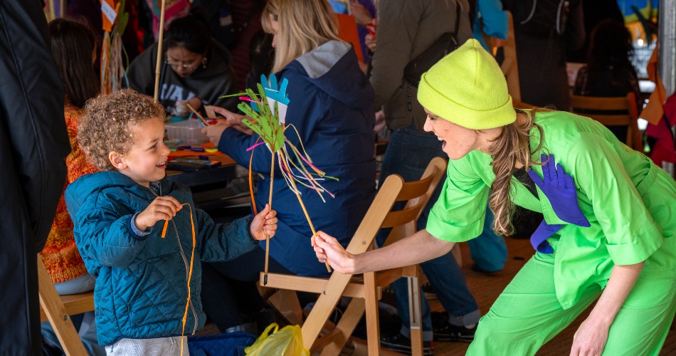 A woman plays a game with a small child.