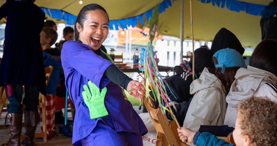 A woman entertains a child as part of Manchester Histories Festival Celebration Day.