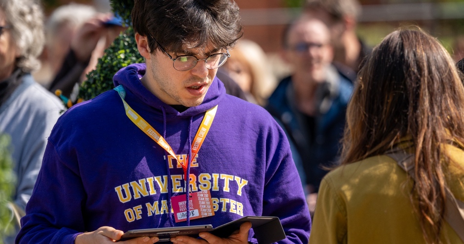 A student ambassador answers a query from a festival goer.