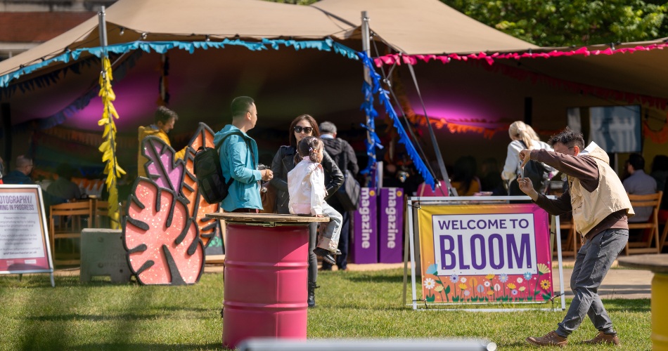 Festival goers take photographs outisde the Bloom tent.
