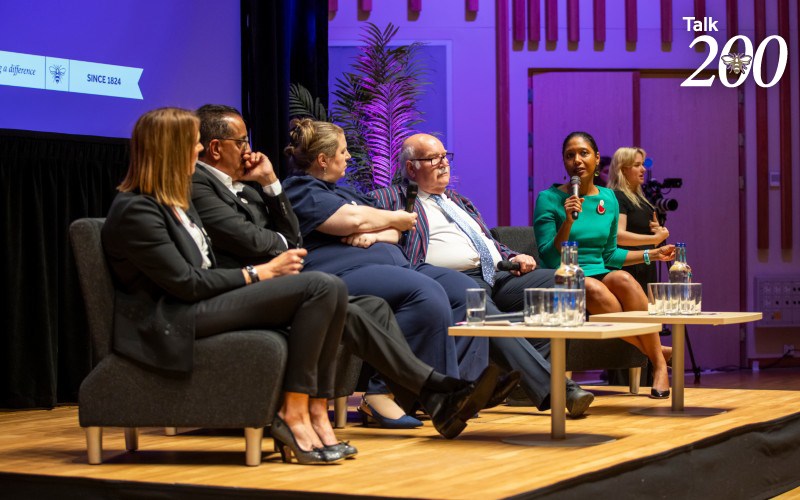 Panelists in discussion at a live Talk 200 event.