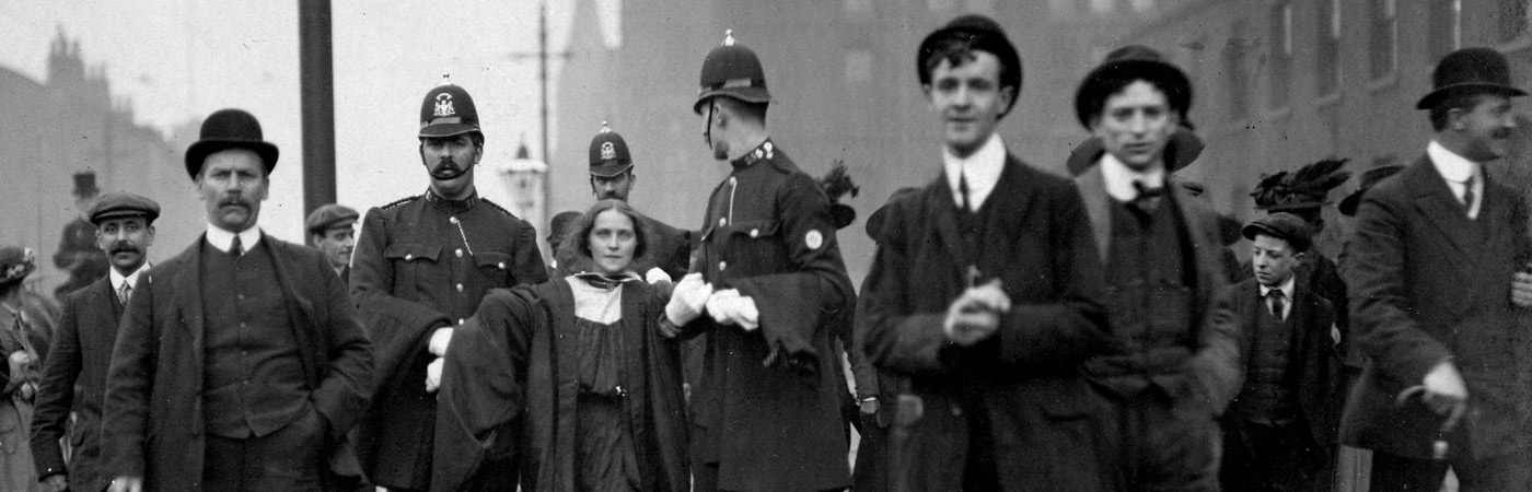 Historical photo of a protester being escorted away by police