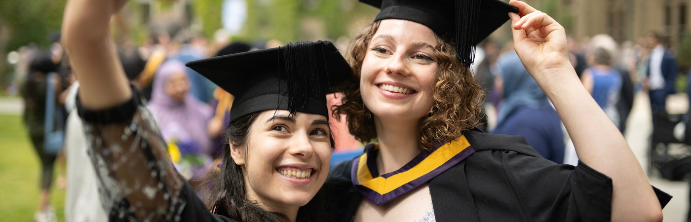 Two graduates taking a selfie