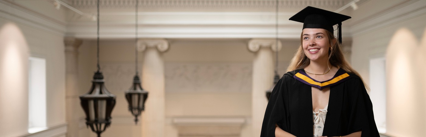 Female graduate on stairwell