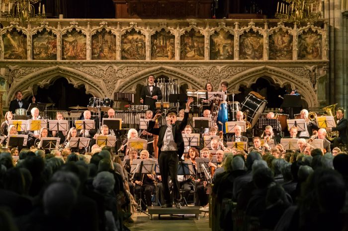 Dr Leo Geyer and orchestra performing the music in concert.