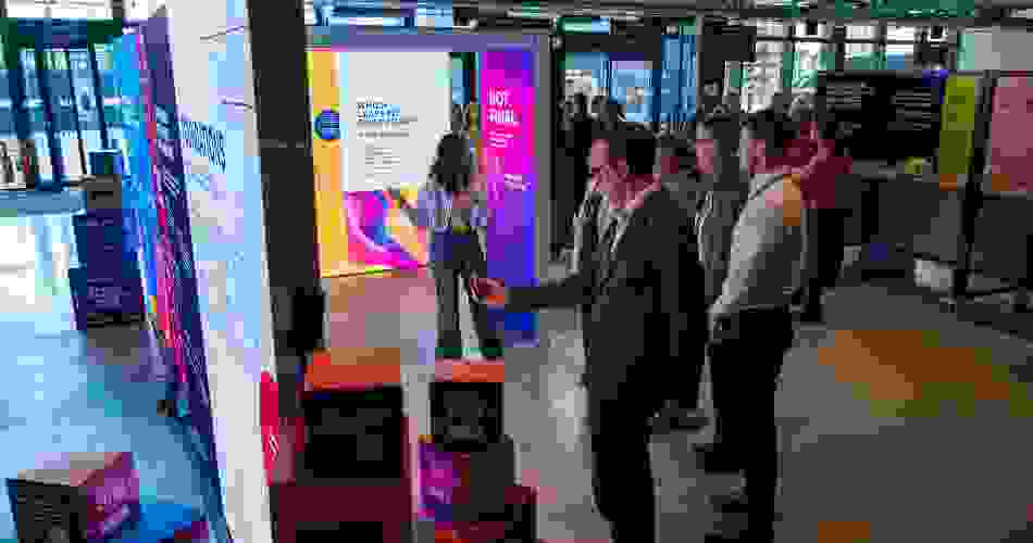 Wide shot of the Ideas Lab with a guide talking through the content of the pop-up exhibition.