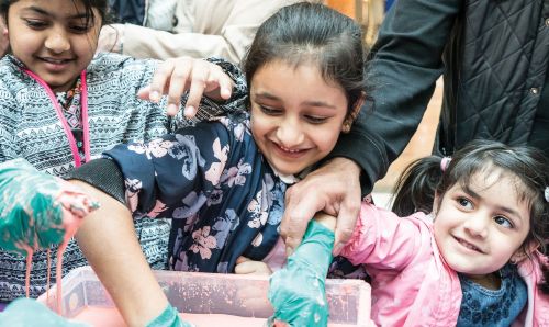 Child playing with slime at Science X