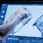 A hand using a scanning machine