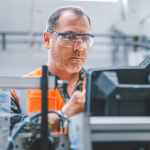 Electrical engineering working in a factory