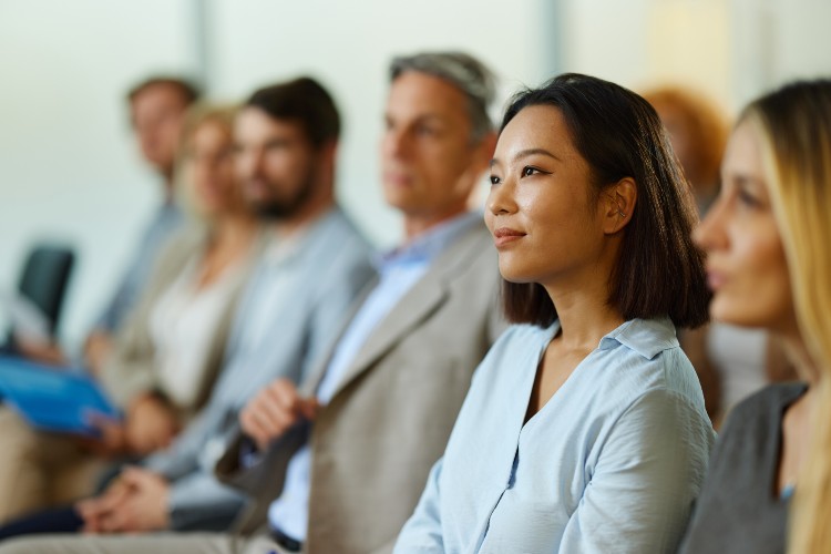 Women and men sat in a seminar room