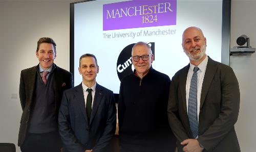 Two men from Manchester and two from Cummins stood together and facing the camera.