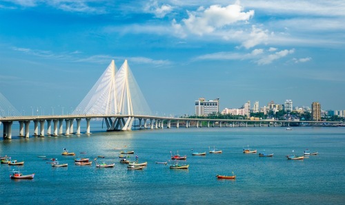 Mumbai, India skyline including a bridge across water.