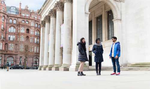 Three international students smiling