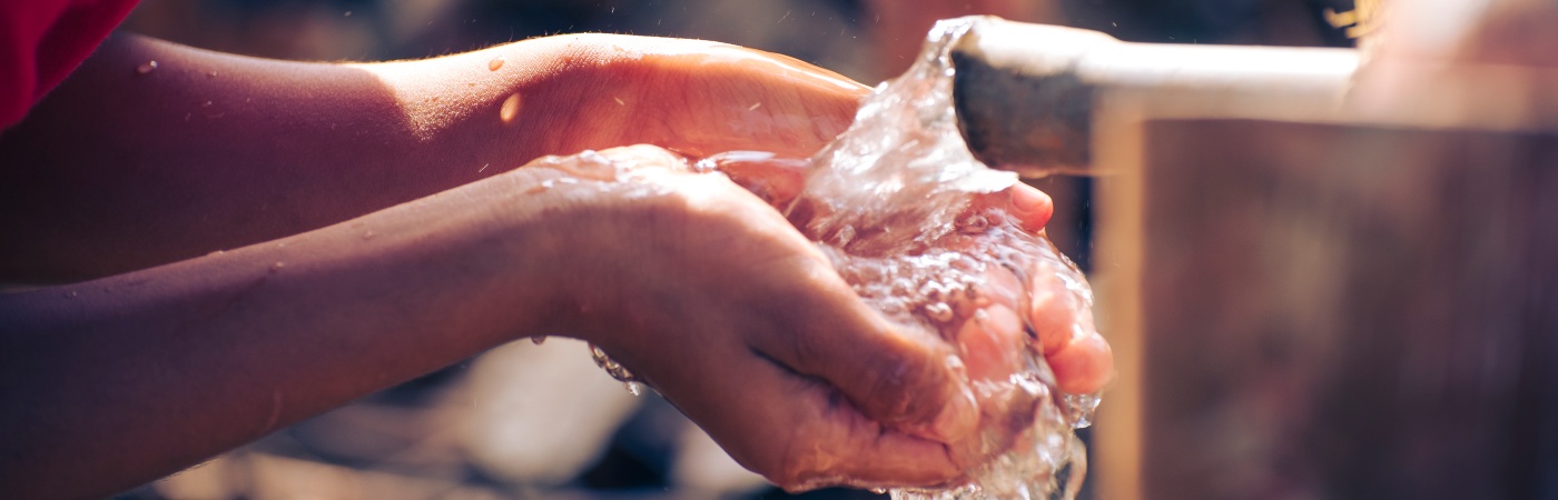 Indian boy drinking water.