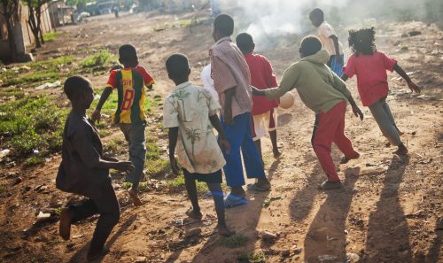 Children in Africa playing football. 