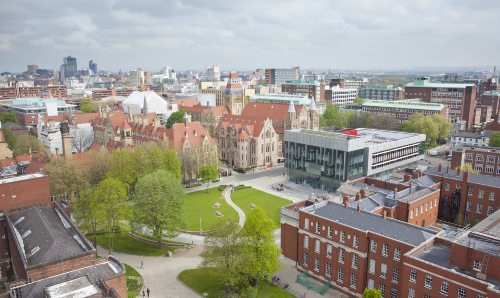 Aerial view of the University campus, showing Gilbert square, and the modern architecture of the Learning Commons beside grand old buildings such as Whitworth Hall and the tower.