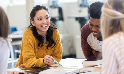Smiling students studying together