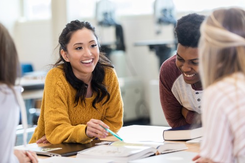 Smiling students studying together