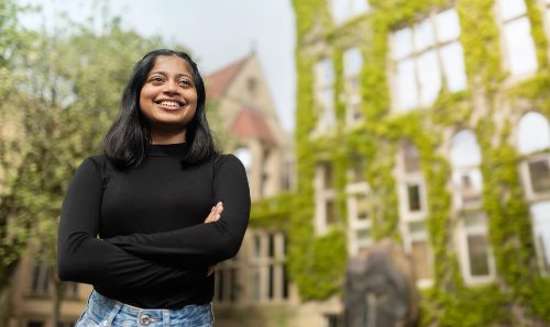 Student smiling against backdrop of Beyer Building