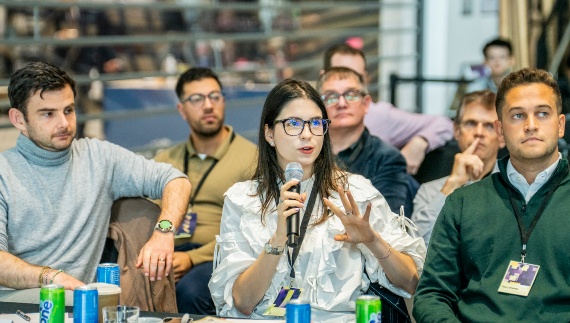 An attendee speaking on a microphone at The University of Manchester Innovation Festival.