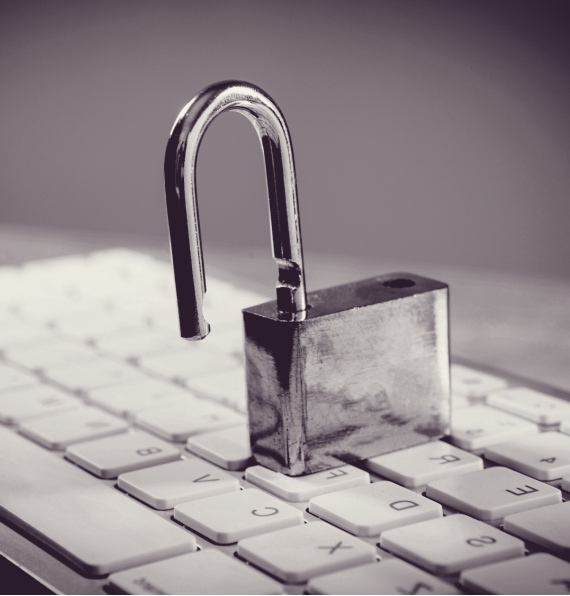 Black-and-white image of an open lock on a keyboard.