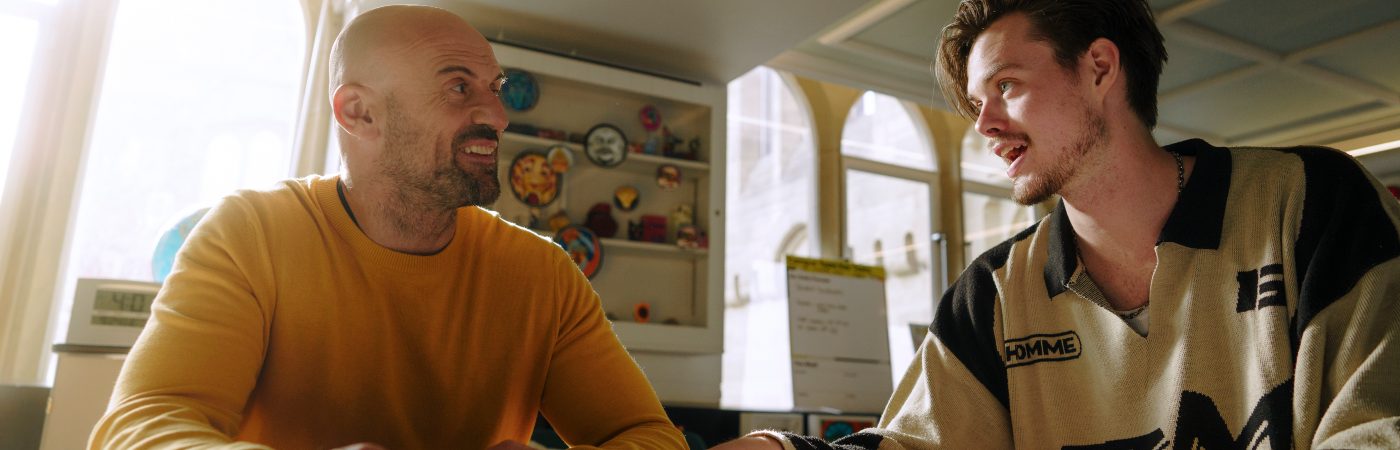 Two University of Manchester colleagues talk in an animated fashion