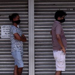 Men in protective masks queuing 