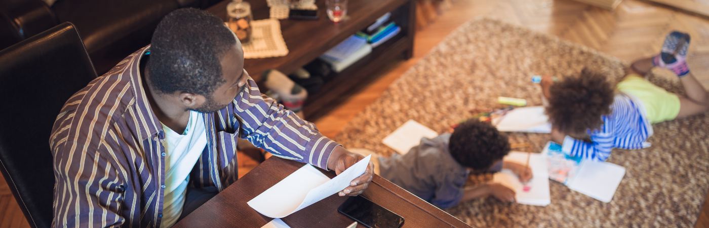 Man working from home and looking after two children