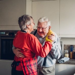 Older couple dancing in kitchen