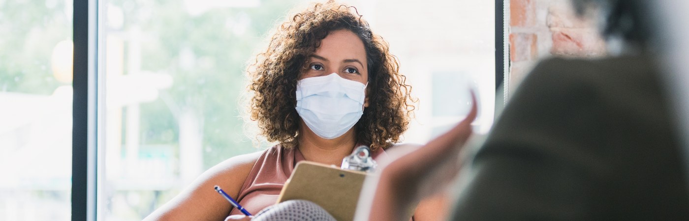 Female counselor wears mask during session