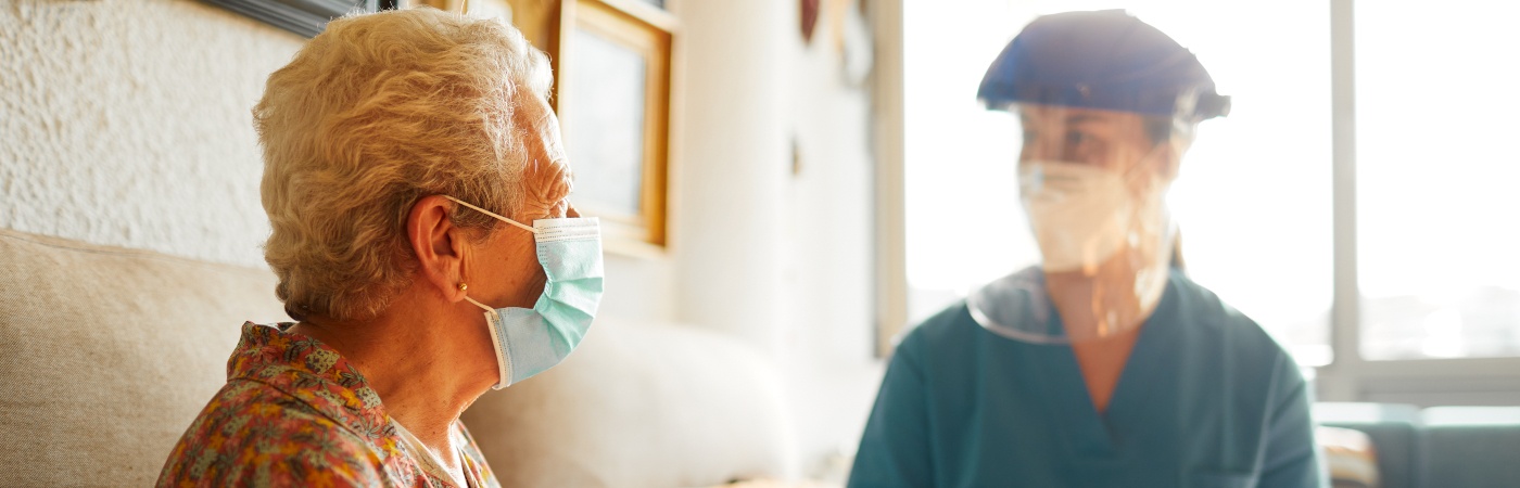 A female doctor visits a senior woman at the nursing home. iStock photo.