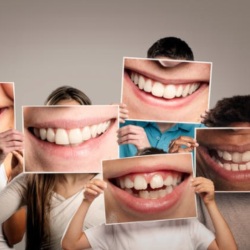 People holding up images of smiles in front of their faces