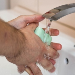 Man washing hands under tap. Image by Gentle07 from Pixabay.