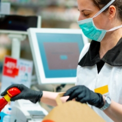 Women packing shopping at a till