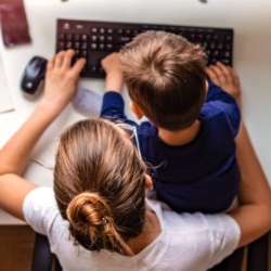 Mother helping her child do schoolwork at home